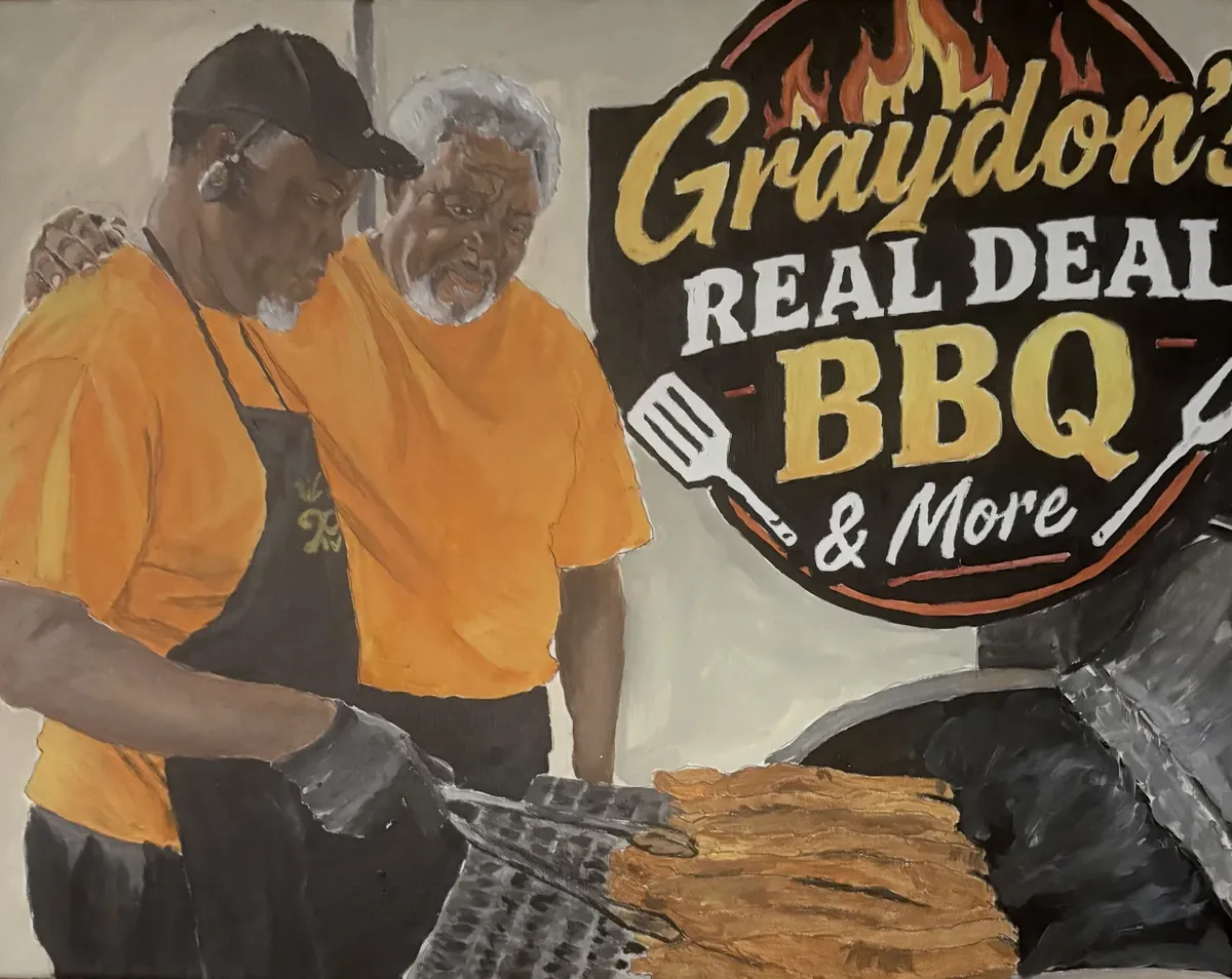 Painting of Daryl Graydon at the grill in an orange shirt and apron, his father's arm around his shoulders, beside the Graydon's Real Deal BBQ & More sign.